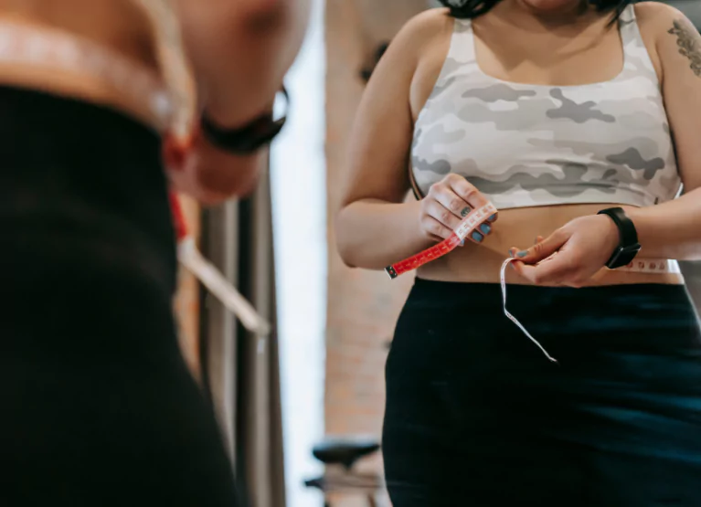 A person measuring their waistline