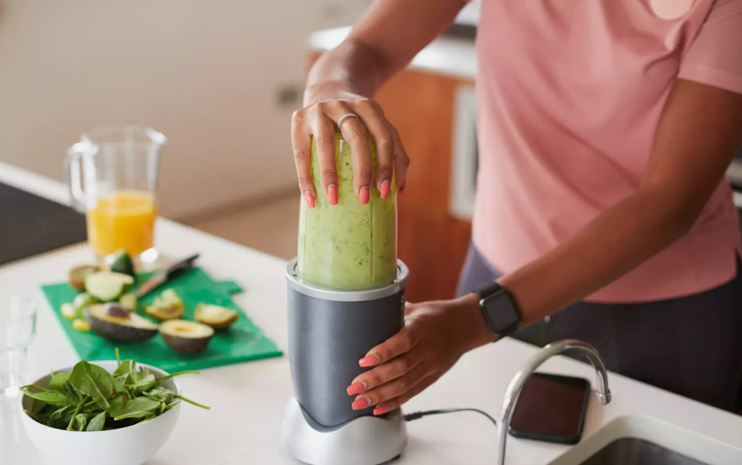 a person making green smoothie 