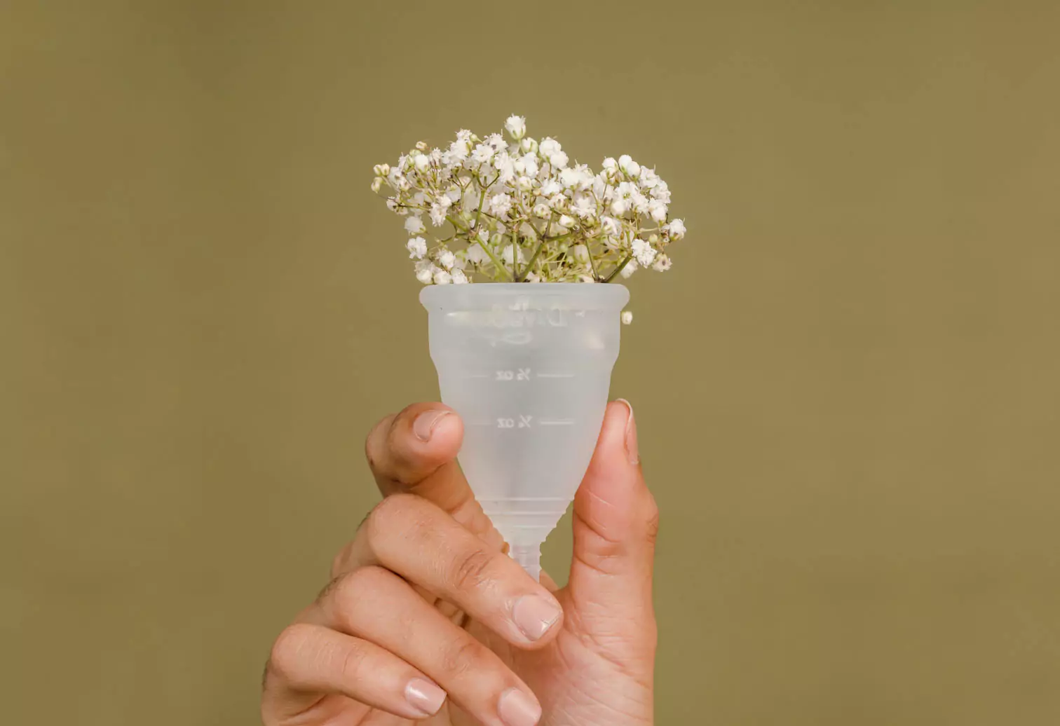 a person holding a menstrual cup