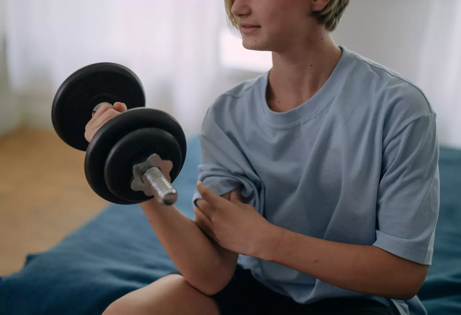 a person holding a dumbbell at home