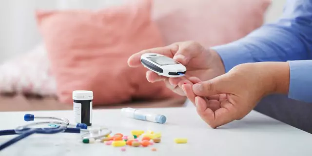 Person pricking their finger for blood glucose testing