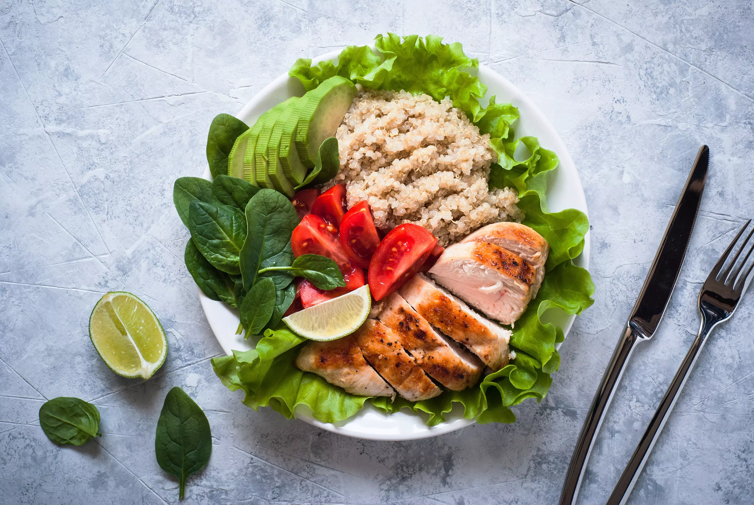 a plate of porridge, chicken, veggies and avocado 