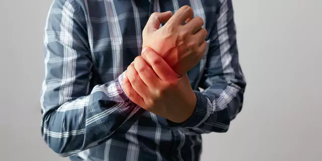 a person having a pain in their wrist 