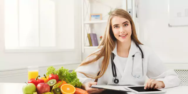 a doctor near a plate of fruits 