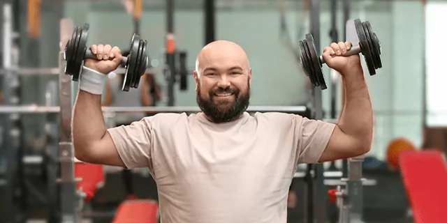 a person holding dumbbells in the gym