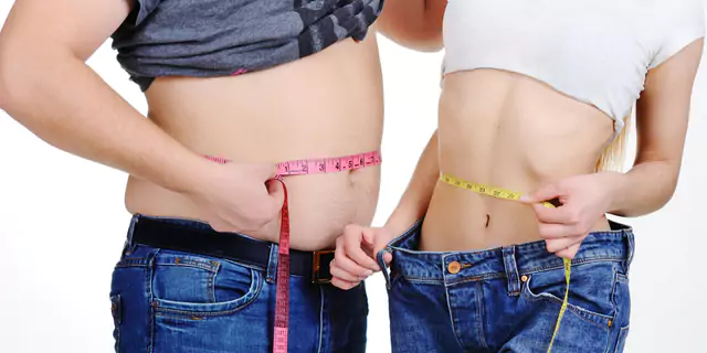 two people who have different sizes measuring their waists 