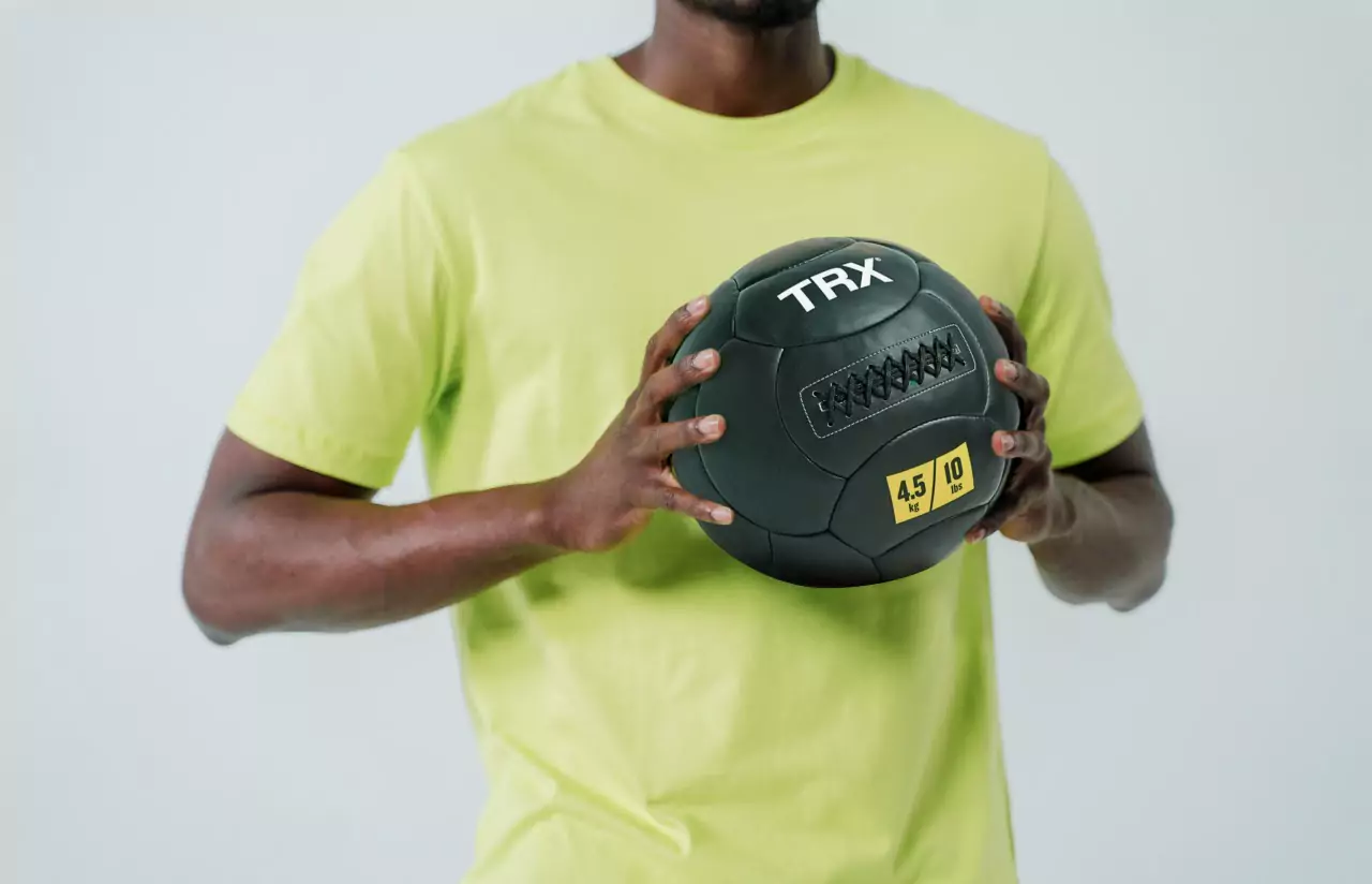 a person holding a TRX Wall Ball