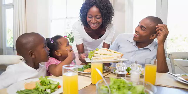 a family of four having breakfast 