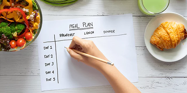 someone writing a meal plan