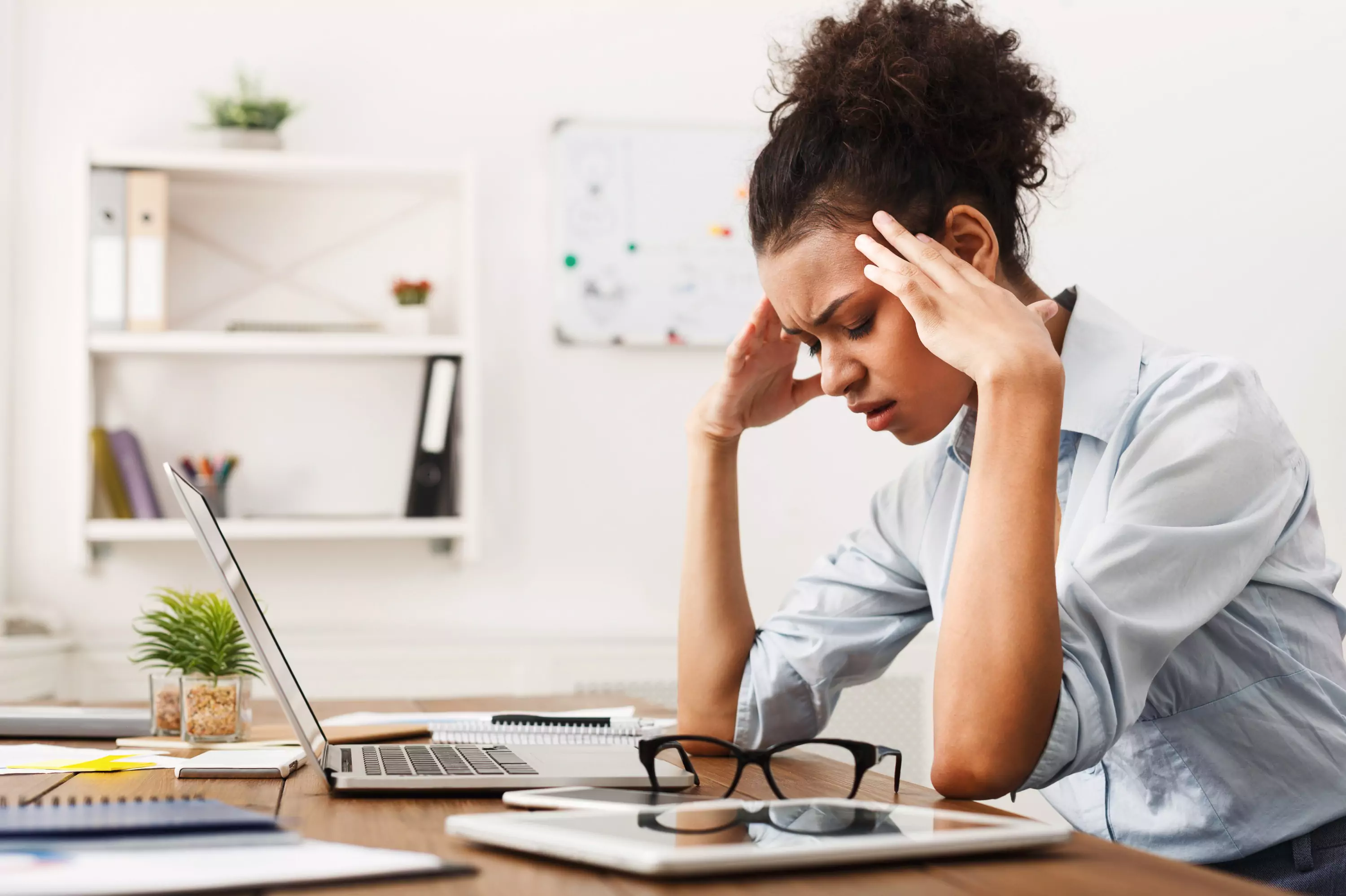 a person sitting at a table looking stressed out 