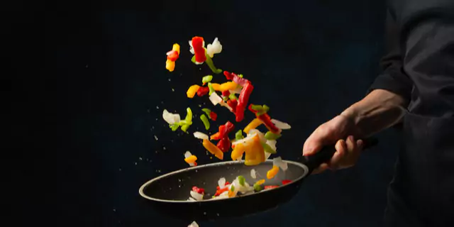 someone frying veggies