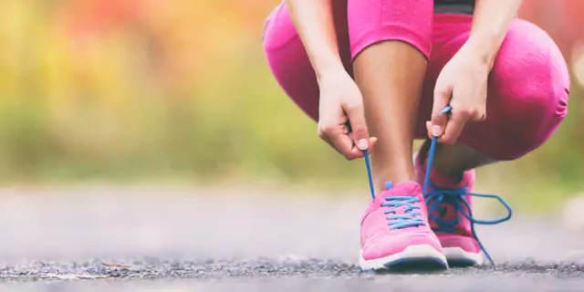 a person tying shoelace