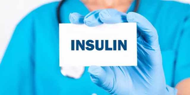 a doctor showing a card with insulin written on it