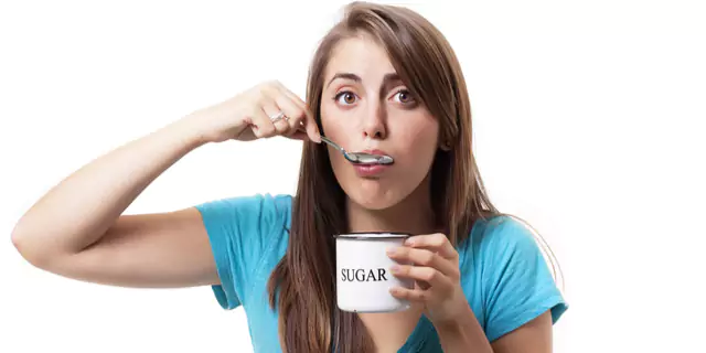 a person eating from a cup with sugar written on it 