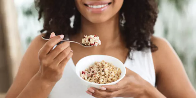 a person eating oatmeal with berries  