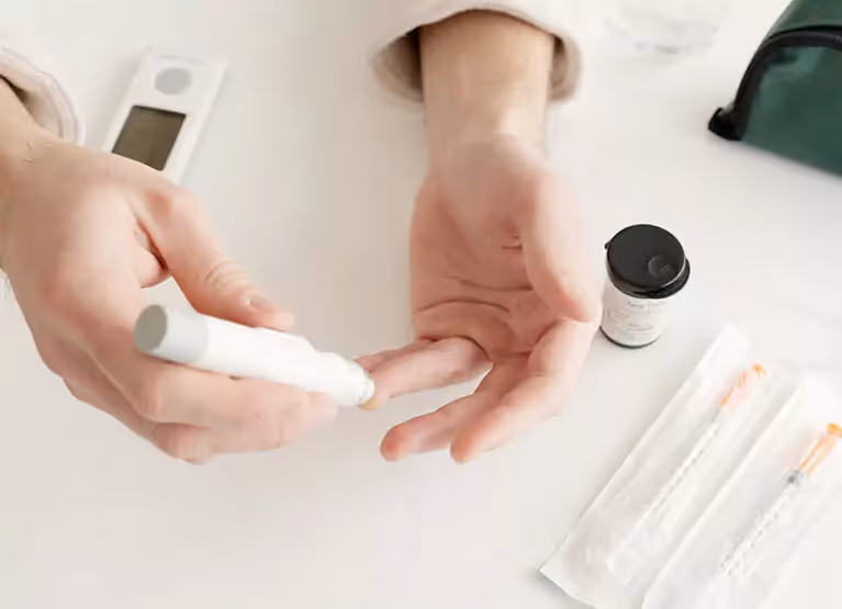 someone pricking their finger to check blood sugar
