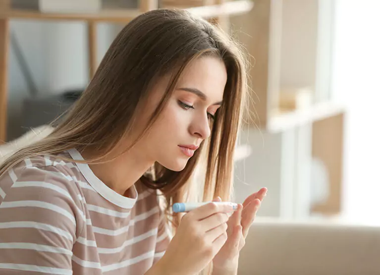 a girl checking her blood sugar