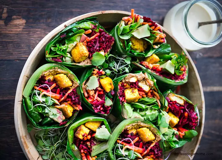 Collard green wrap with tempeh and shredded beets and carrots