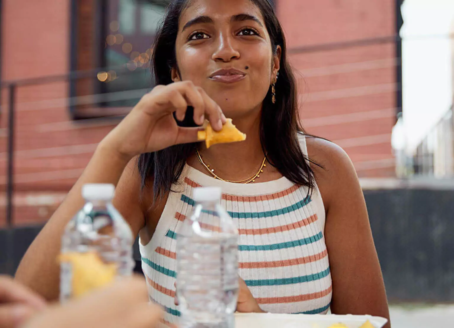 a girl smiling and eating food