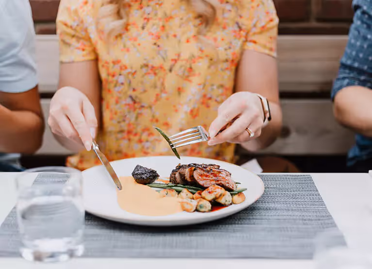 a woman eating a meal at a table