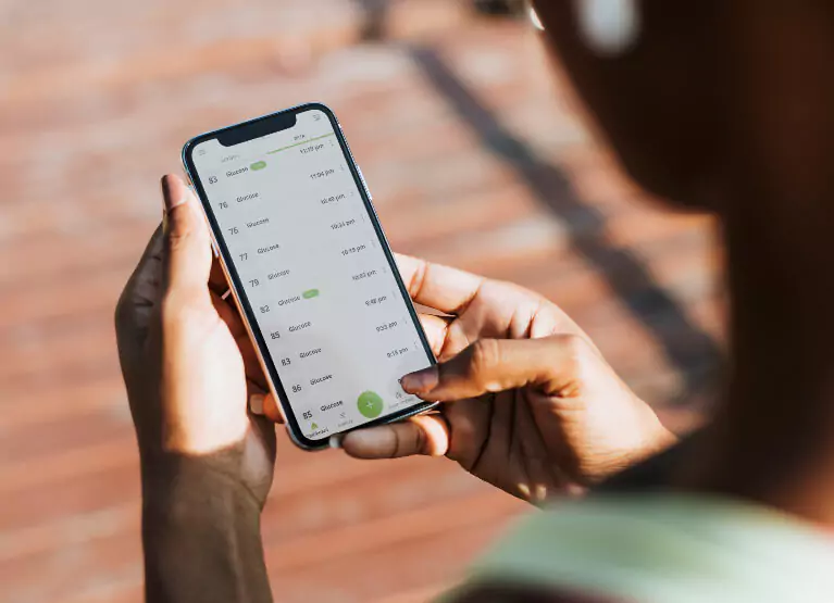 Person checking their glucose levels on Nutrisense App