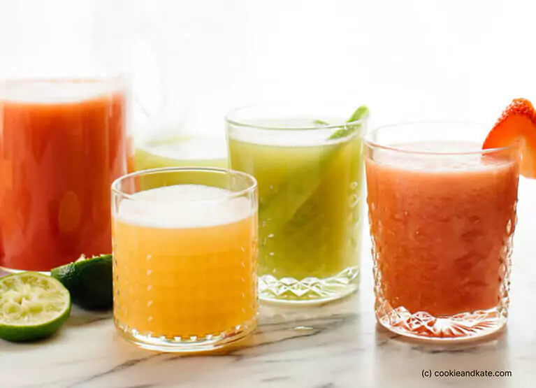 four glasses of flavored agua fresca