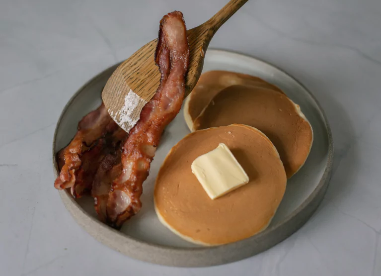 plate of bacon with pancakes