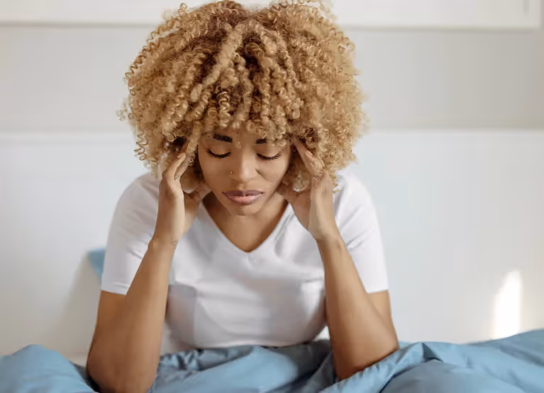 a woman feeling sick in bed