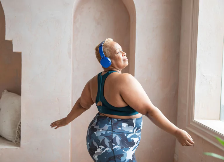 a woman dancing with headphones on