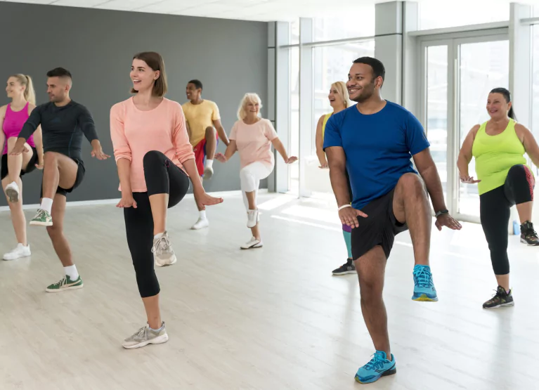 a class full of people doing zumba