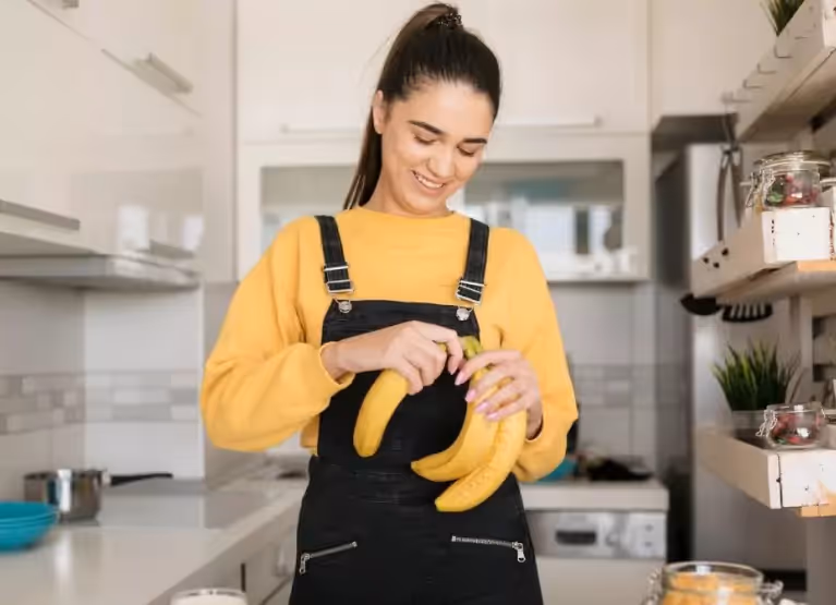 a girl holding some bananas