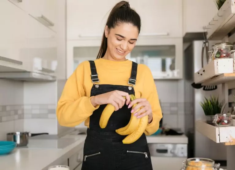 a girl holding some bananas