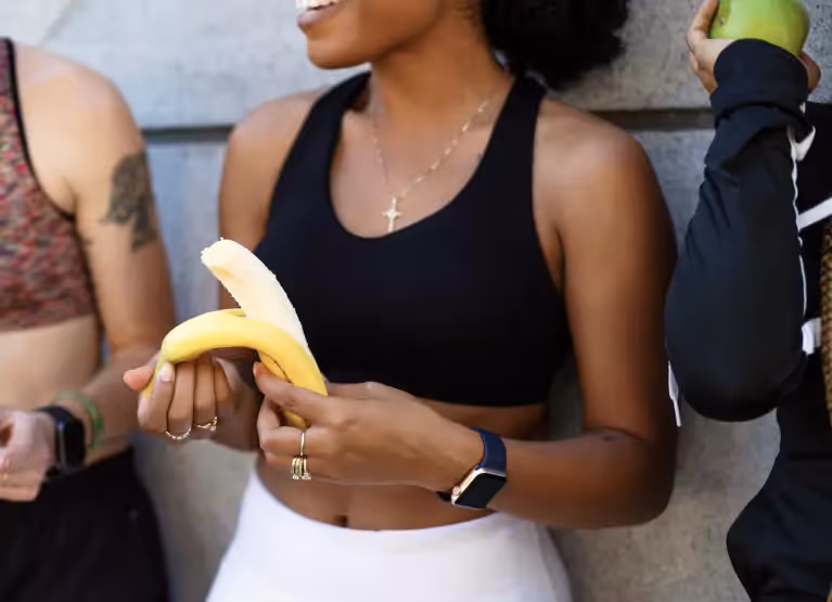 a girl holding a banana