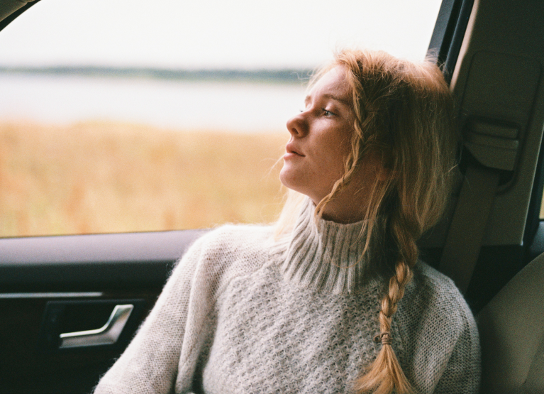 a girl sitting in the car