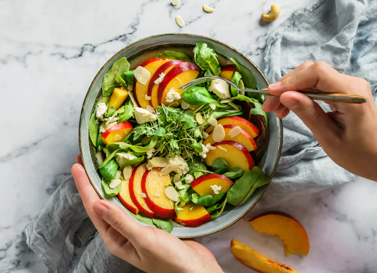 Colorful salad bowl with leafy greens and apples