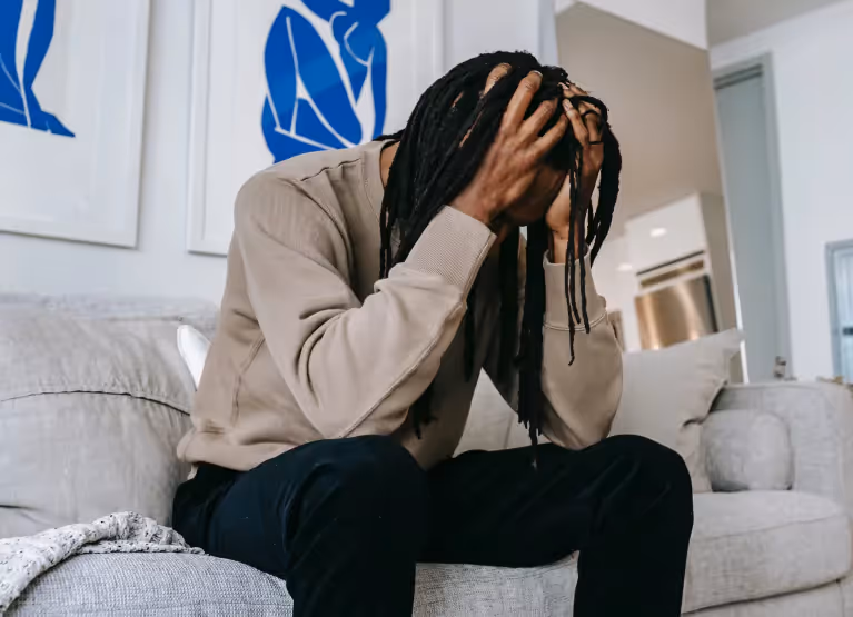 Person holding head in their hands, looking stressed out