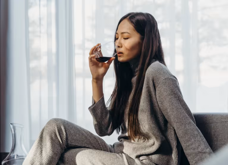 Woman drinking wine at home