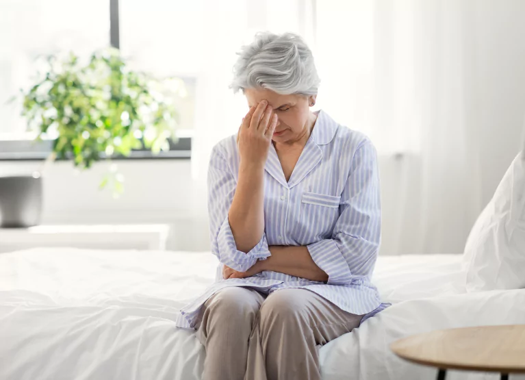 a woman looking frustrated and sitting on her bed