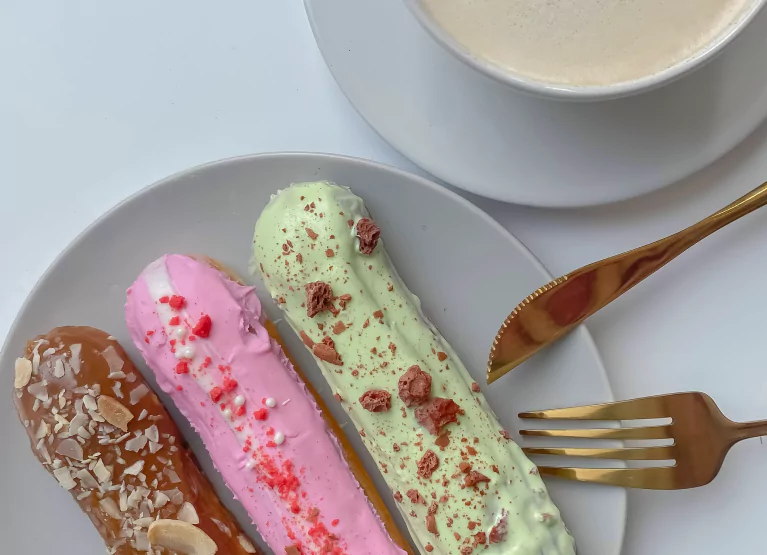 a plate with three eclairs