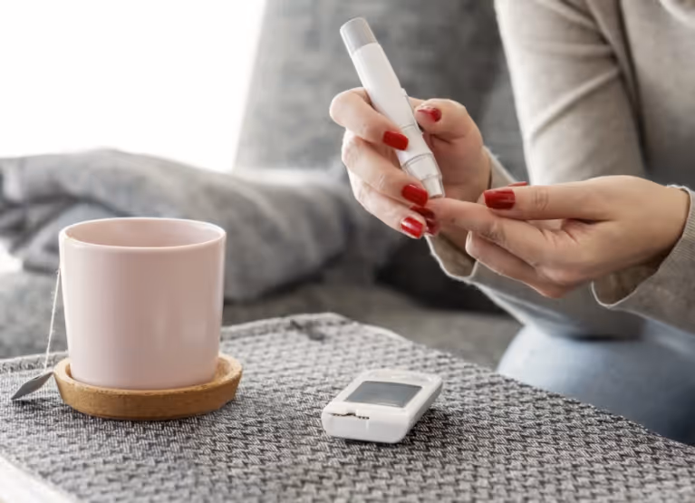 Person pricking finger to check blood glucose