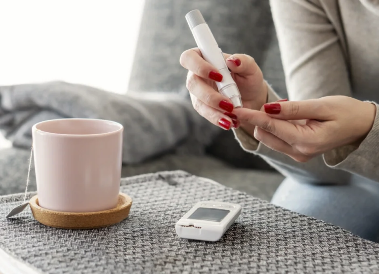 Person pricking finger to check blood glucose