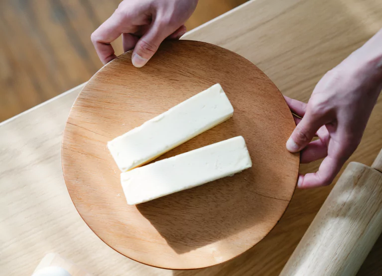 a plate with two sticks of margarine