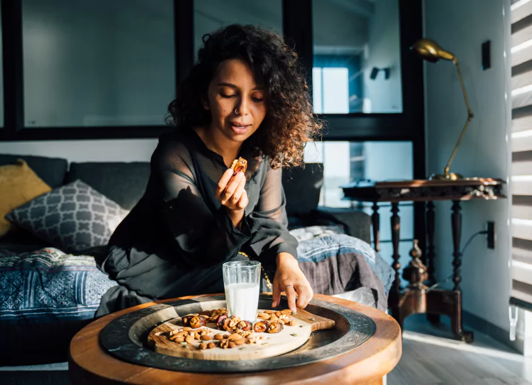 a woman holding a piece of food in her hand