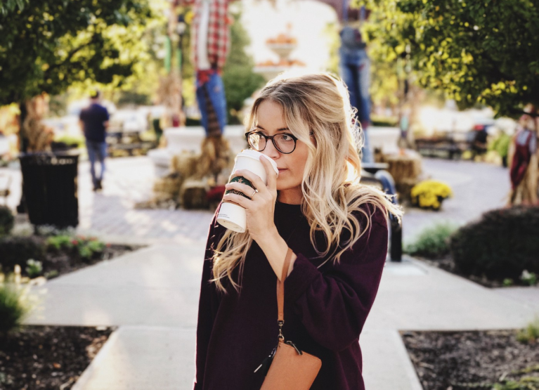 a girl drinking a pumpkin spice latte