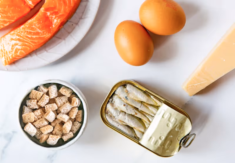 Table with salmon, eggs, sardines, and wheat crackers