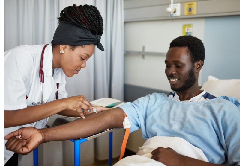 Doctor preparing to draw blood from patient