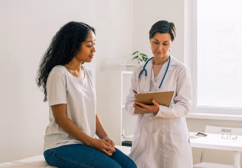 Doctor talking to patient in office