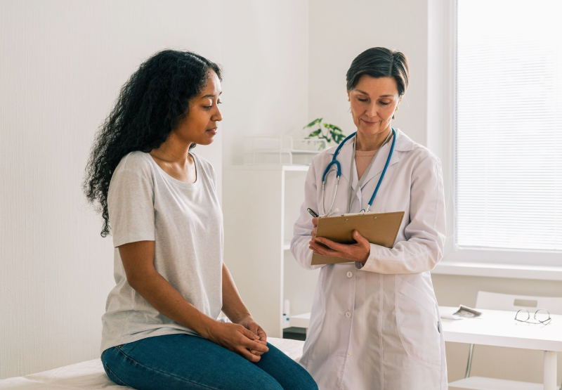 Doctor talking to patient in office