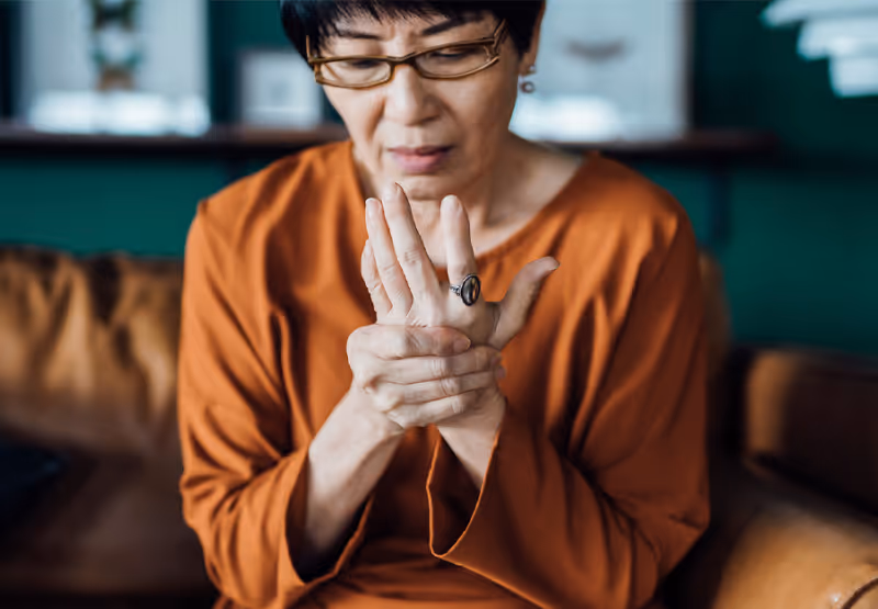 Woman clutching her hand