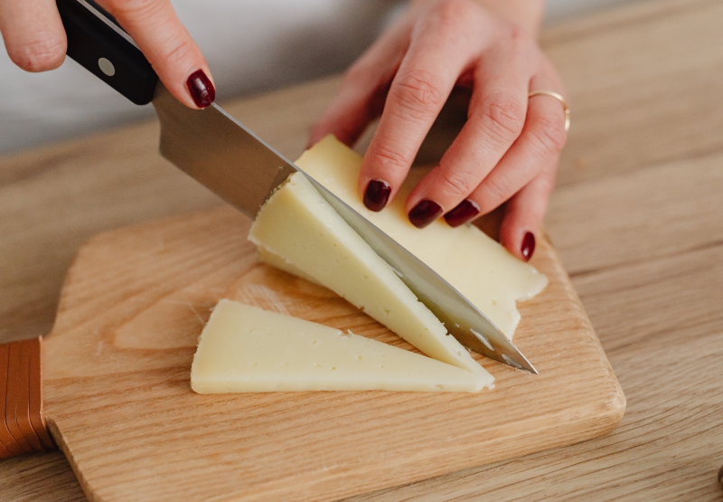 Woman cutting cheese